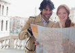© Sam Edwards/KOTO - Smiling couple looking down at map in Venice