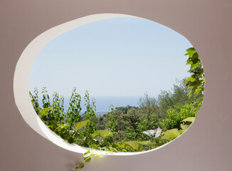 View of garden through oval window