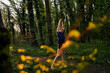 © Westend61 - Full length of girl stretching with arms raised in forest