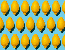 Seamless Pattern Of Ripe Lemons Against Blue Background
