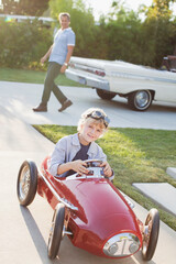 Wall Mural - Smiling boy playing in go cart