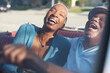 © Sam Edwards/KOTO - Older couple laughing in convertible