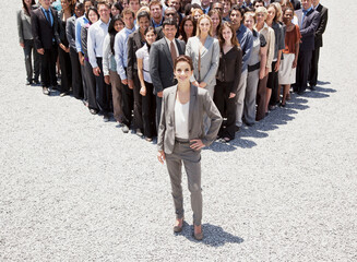 Portrait of confident businesswoman with team of business people 