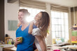 © Paul Bradbury/KOTO - Smiling couple hugging in kitchen