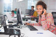 © Paul Bradbury/KOTO - Businesswoman talking on phone at desk