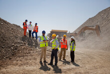 Business People And Workers Talking In Quarry