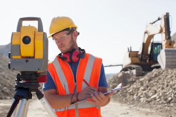 Wall Mural - Worker using leveling equipment in quarry