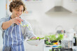 © Tom Merton/KOTO - Man making salad in kitchen