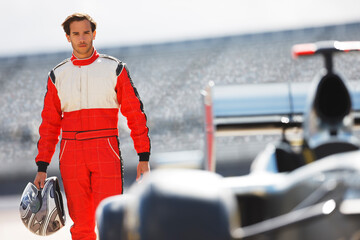 Racer carrying helmet on track