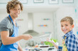 © Tom Merton/KOTO - Father and son baking in kitchen