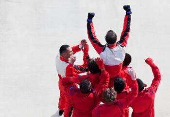 Racer and team cheering on track