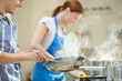© Tom Merton/KOTO - Couple cooking in kitchen