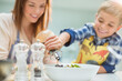 © Tom Merton/KOTO - Mother and son making salad in kitchen