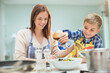 © Tom Merton/KOTO - Mother and son making salad in kitchen