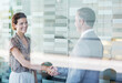 © Robert Daly/KOTO - Business people shaking hands in office
