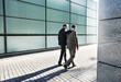 © Robert Daly/KOTO - Businessmen talking on city street