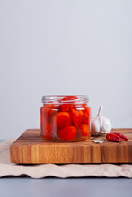 Fermented Tomatoes On A Table In A Glass Jar