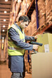 © Paul Bradbury/KOTO - Worker scanning box in warehouse