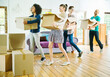 © Robert Daly/KOTO - Friends unpacking boxes in new home