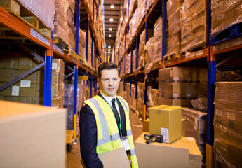 Wall Mural - Businessman standing in warehouse