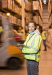 © Paul Bradbury/KOTO - Worker holding clipboard in warehouse