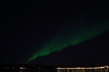 aurora borealis in autumn night with city light background