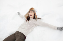 Enthusiastic Woman Making Snow Angel