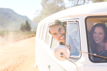 Wall Mural - Portrait of smiling couple in camper van