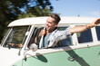 © Martin Barraud/KOTO - Man leaning head out camper van window