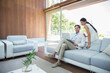 © Robert Daly/KOTO - Couple using laptop on sofa