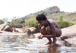 © Martin Barraud/KOTO - Woman cupping water in river