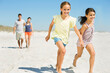 © Dan Dalton/KOTO - Girls holding hands and running on beach
