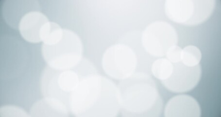 White particles bokeh with blurred depth of field. Moving floating particle animation. Seamless Loop.