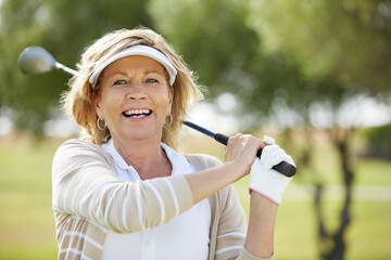 Wall Mural - Senior woman playing golf on course