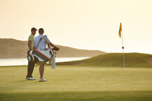 Men On Golf Course Overlooking Ocean