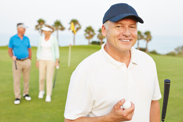 Wall Mural - Smiling senior man on golf course