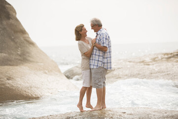 Poster - Senior couple hugging on beach