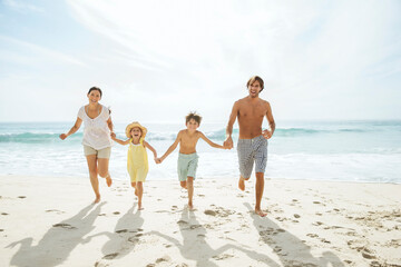 Family running together on beach