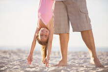 Father And Daughter Playing On Beach