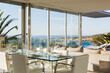 Set table in modern dining room overlooking ocean