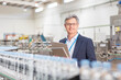 © Martin Barraud/KOTO - Supervisor smiling in bottling plant