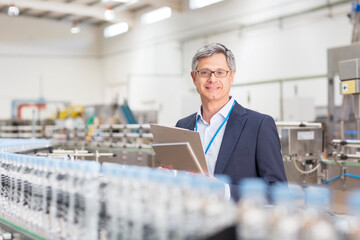 Supervisor smiling in bottling plant