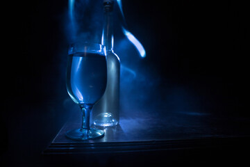 Goblet of white wine on wooden table on wooden wall background