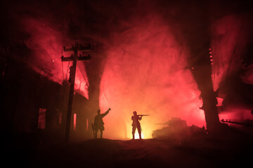 War Concept. Military silhouettes fighting scene on war fog sky background, World War Soldiers Silhouette Below Cloudy Skyline At night.