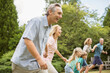 © Paul Bradbury/KOTO - Multi-generation family holding hands and running