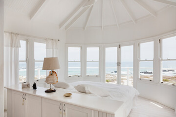 White bedroom overlooking ocean