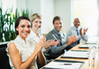 © Paul Bradbury/KOTO - Business people clapping in meeting