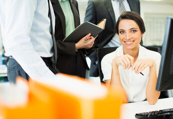 Wall Mural - Businesswoman smiling at computer in office