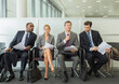 © Chris Ryan/KOTO - Business people sitting in waiting area