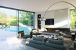 © Astronaut Images/KOTO - Modern living room overlooking patio with swimming pool
